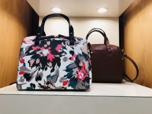 Pamela Lutrell with printed handbags for spring at Dillards