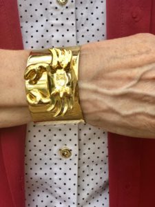 Pamela Lutrell in gold cuff with a crab